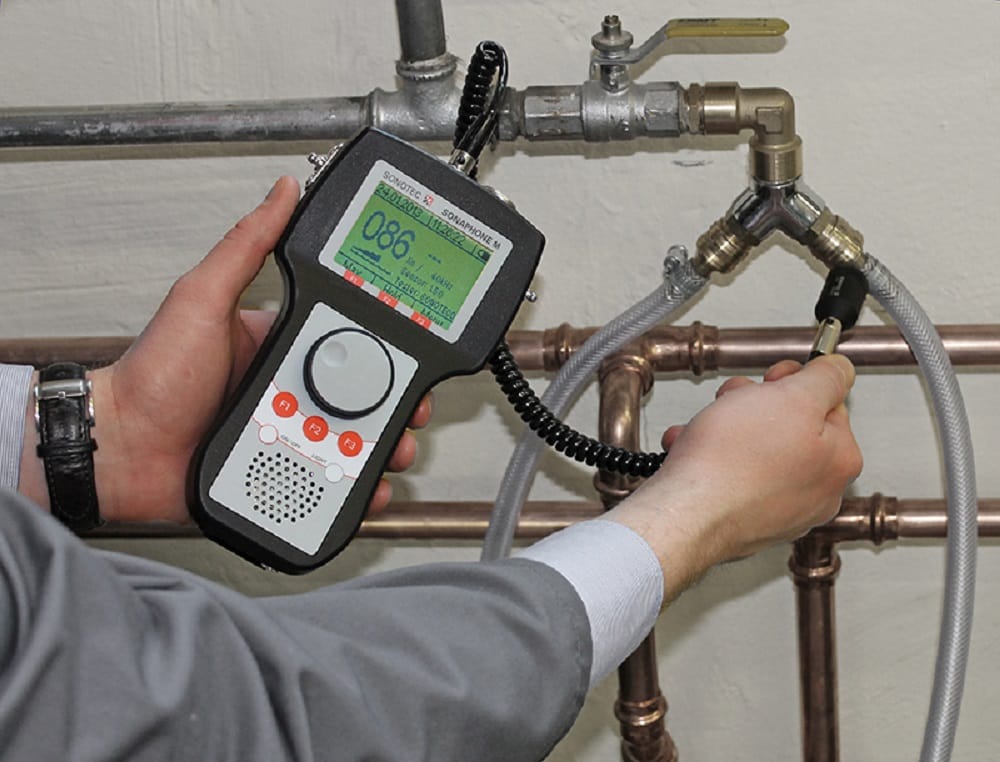 Plumber testing pipes with electronic leak detection equipment in Douglasville