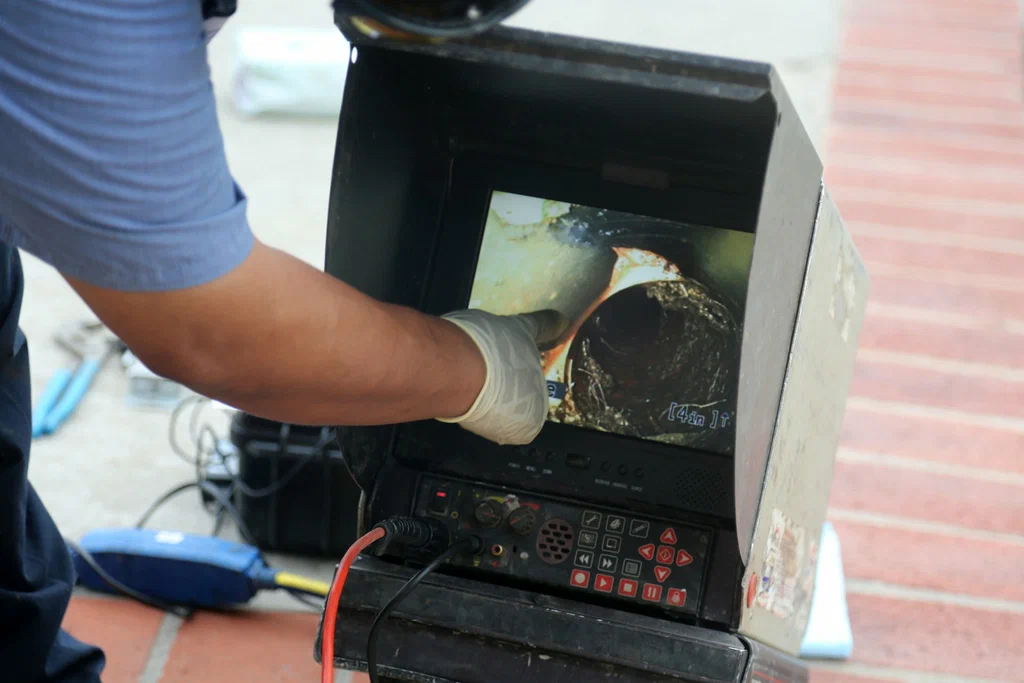 Technician viewing a drain inspection camera in Douglasville