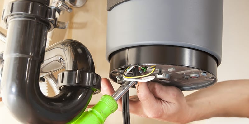Technician repairing the heating element of a water heater in Douglasville