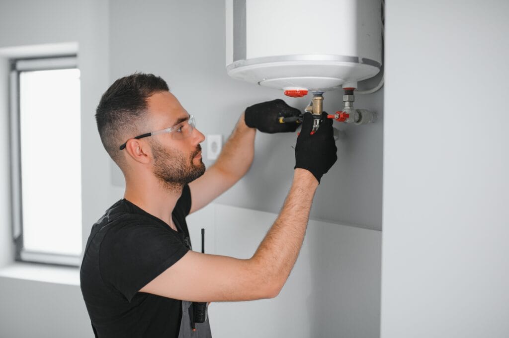 Technician performing water heater maintenance in Douglasville