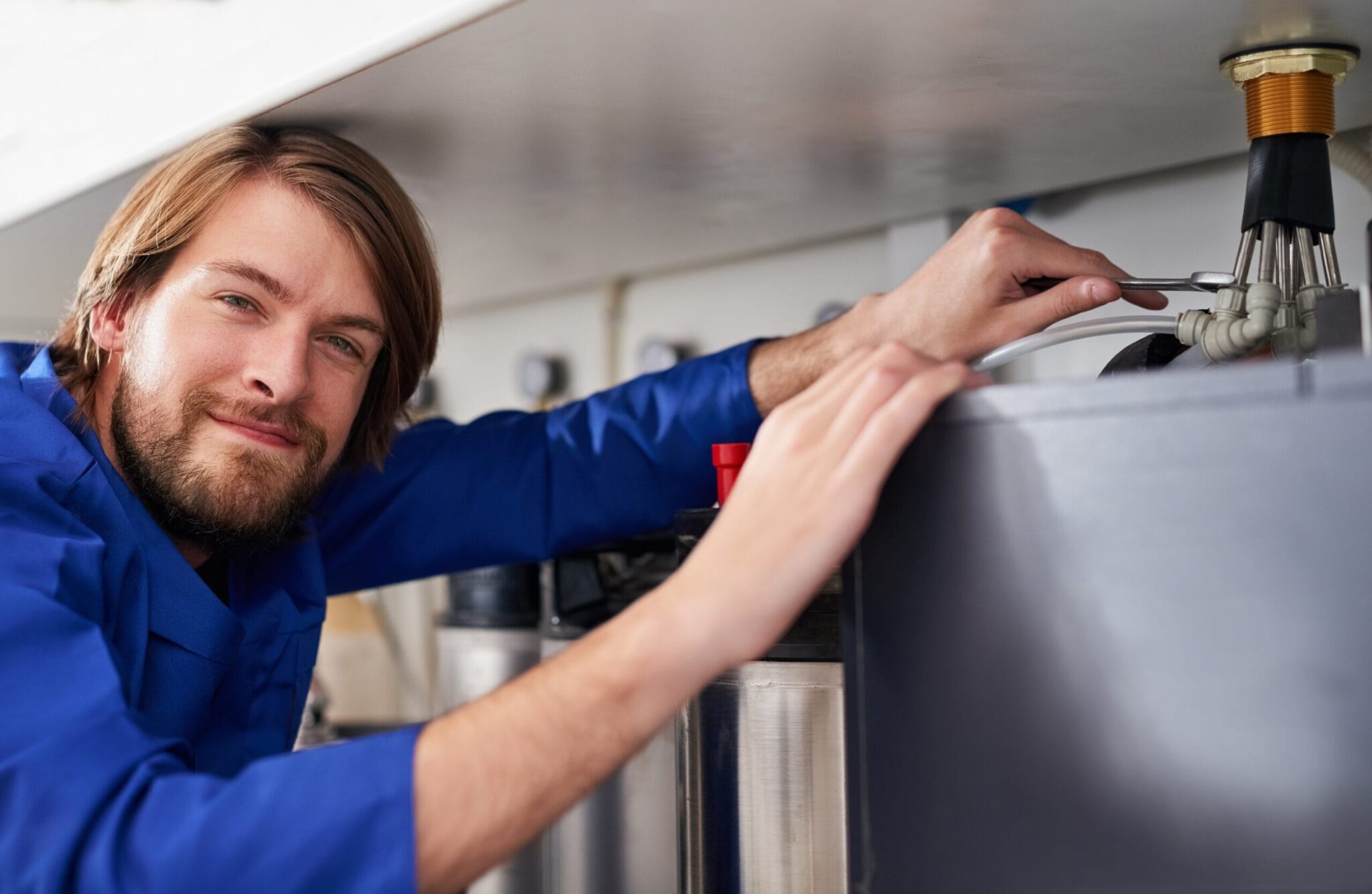 Technician servicing a residential water heater tank in Douglasville