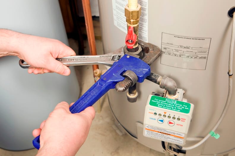 Plumber repairing a water heater valve in Douglasville